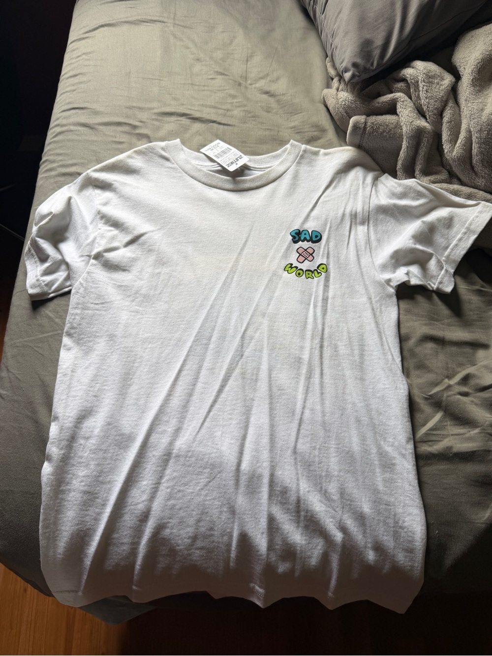 Zumiez White Tee with Colorful 'Sad World' Chest Graphic